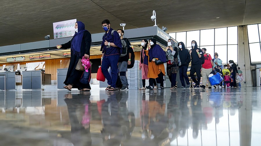 Afghans displaced from their homes due to the Taliban takeover arrive at Washington Dulles International Airport in Chantilly, Va., on Monday, August 30, 2021.