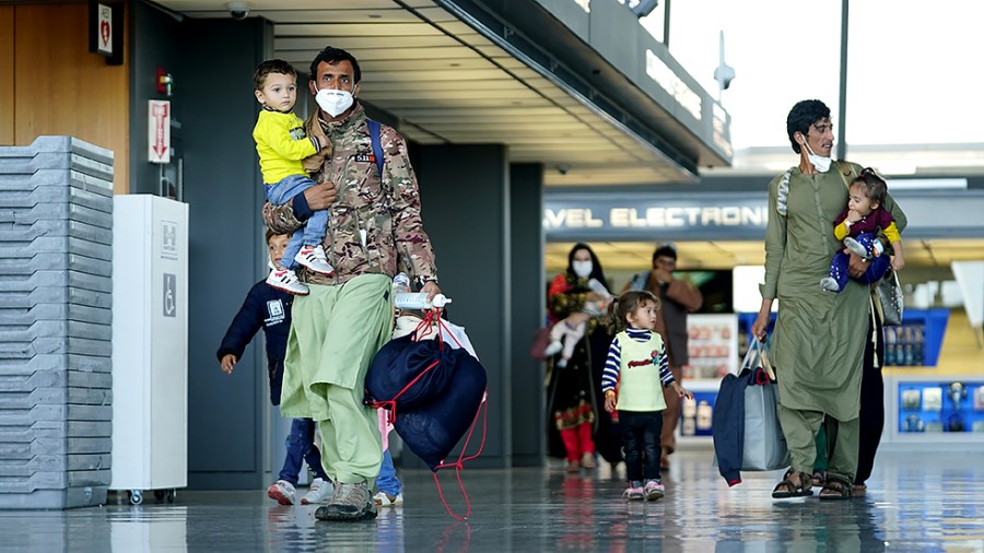 Afghan refugees displaced from their homes due to the Taliban takeover arrive at Washington Dulles International Airport in Chantilly, Va., on Monday, August 30, 2021.