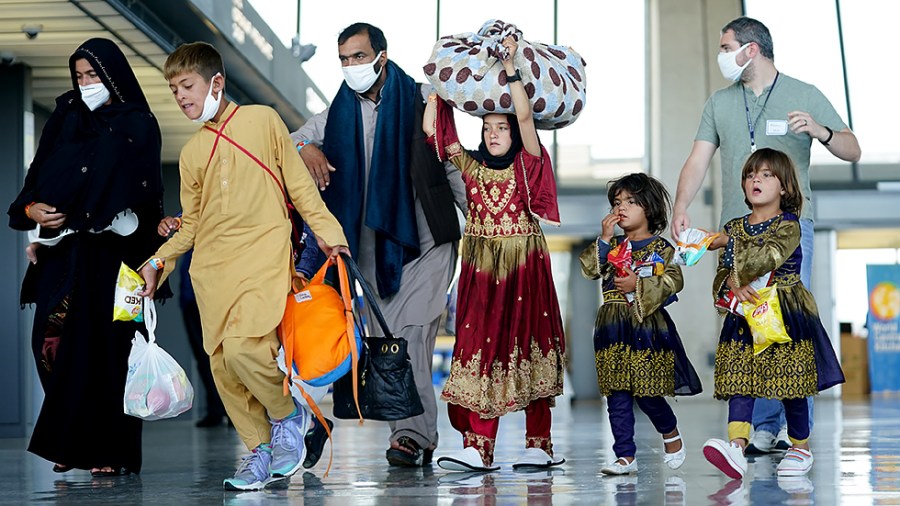 Afghans displaced from their homes due to the Taliban takeover arrive at Washington Dulles International Airport in Chantilly, Va., on Monday, August 30, 2021.