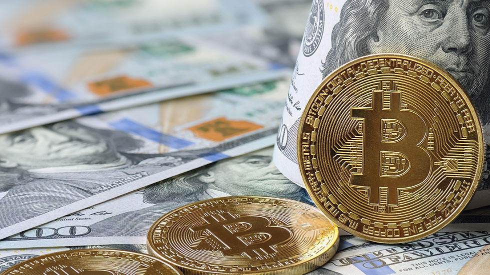 Bitcoins lying on American money