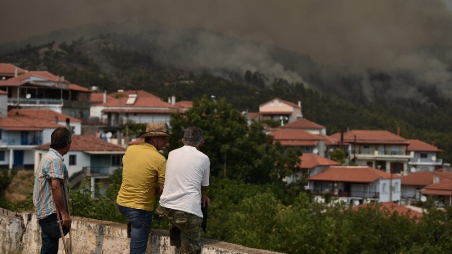 Greek residents watch the smoke from wildfires