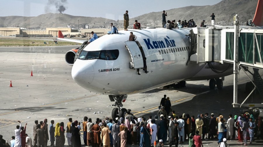 Crowds flood the tarmac at Kabul airport