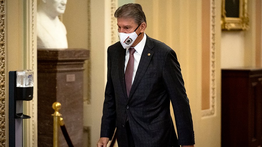 Sen. Joe Manchin (D-W.Va.) is seen near the Senate Chamber as the Senate votes on the bipartisan infrastructure bill on Tuesday, August 10, 2021.