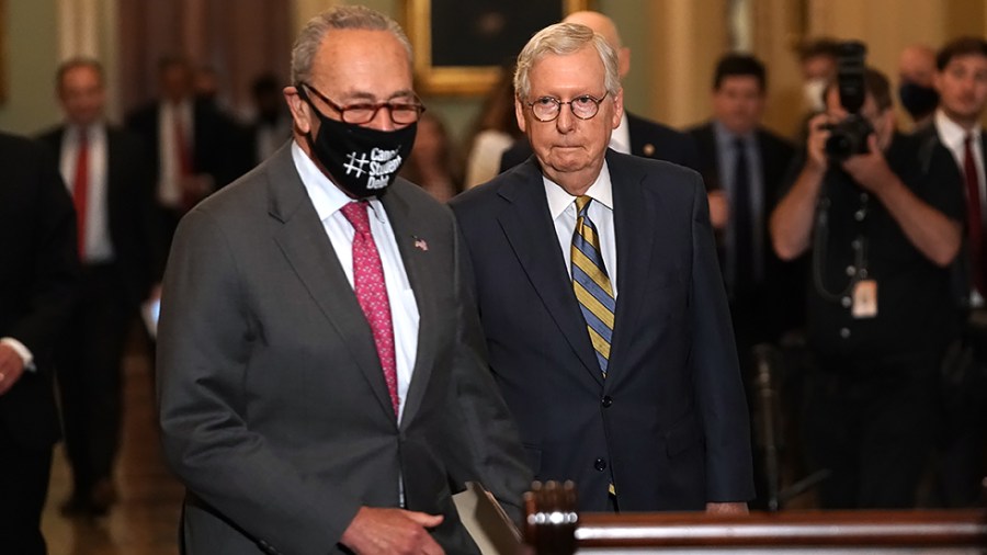 Minority Leader Leader Mitch McConnell (R-Ky.) watches as Majority Leader Charles Schumer (D-N.Y.) arrives first for his press conference after the weekly policy luncheon on Tuesday, August 3, 2021.