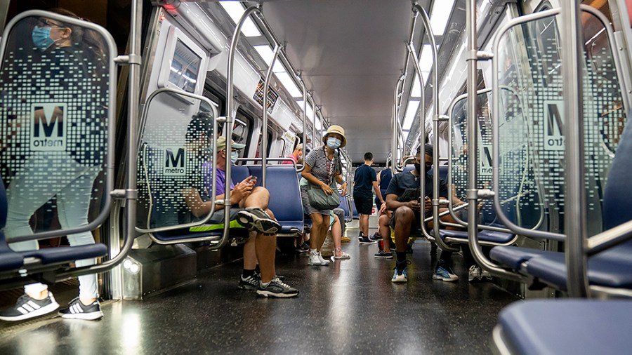 Metro riders are seen on a Blue Line train at L'Enfant Plaza Metro Station in Washington, D.C., on Wednesday, August 4, 2021.