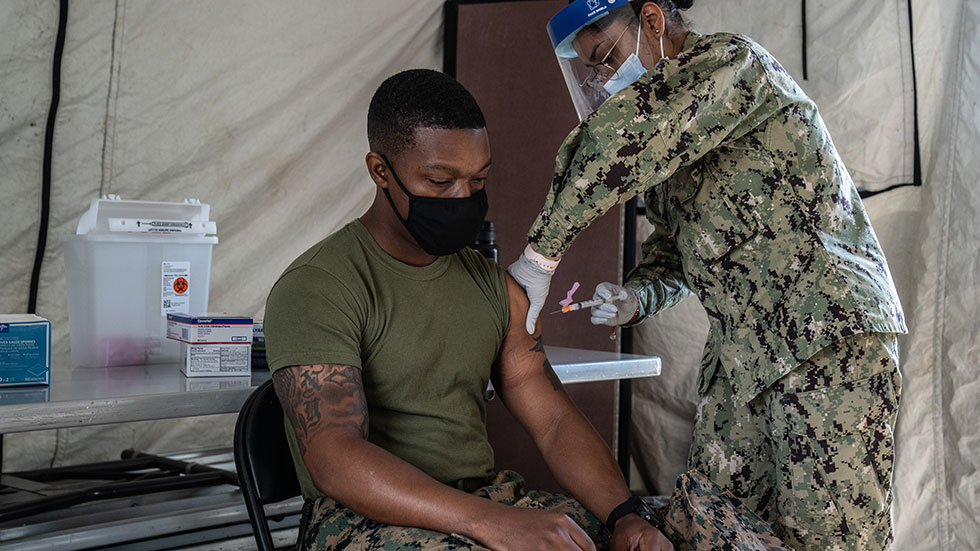 A U.S. Marine receives the COVID-19 vaccine. 