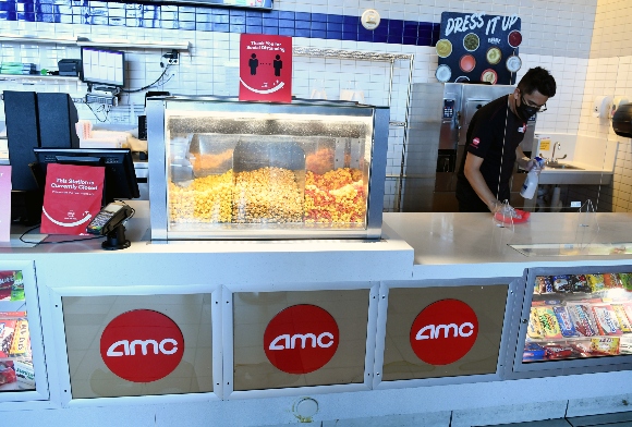 An employee sanitizes the concession stand at AMC Town Square 18 in Las Vegas