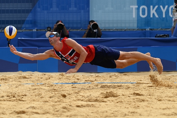 Norway's Anders Berntsen Mol reaches for the ball in their men's beach volleyball quarter-final match