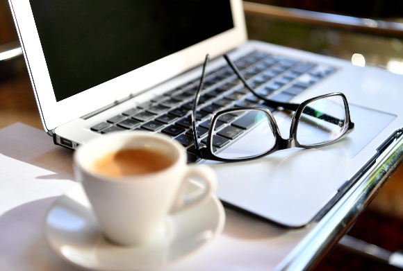 Glasses on a laptop at a home office desk