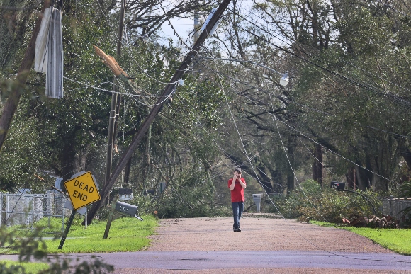 Trees and utility lines damaged by Hurricane Ida block a road