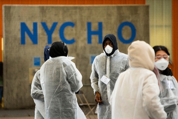 Workers wait at a vaccination clinic