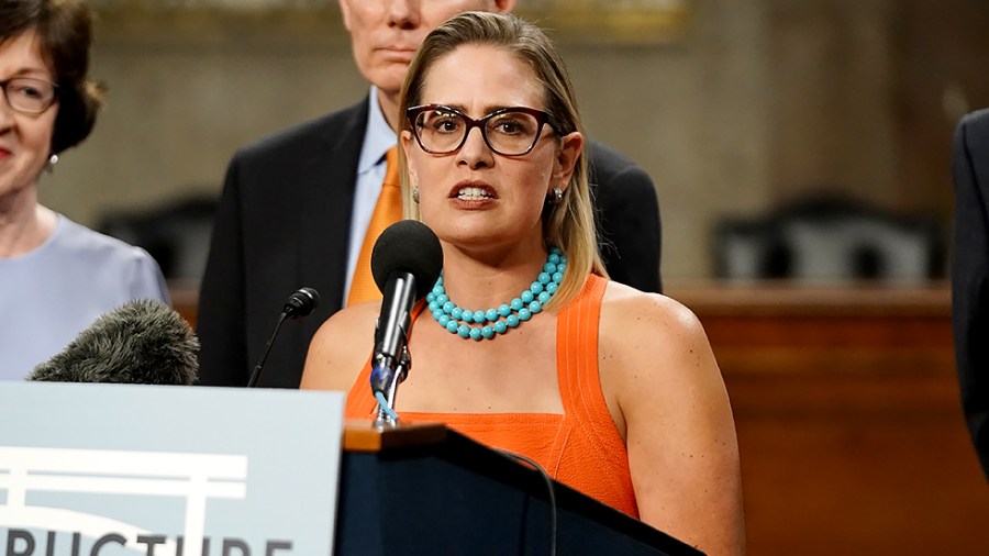 Sen. Kirsten Sinema (D-Ariz.) addresses reporters after a key vote regarding bipartisan infrastructure legislation on Wednesday, July 28, 2021.