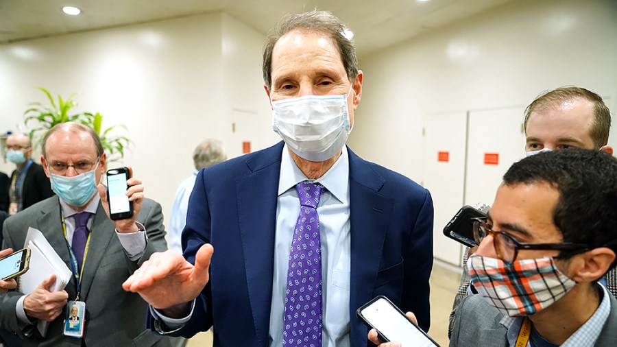 Sen. Ron Wyden (D-Ore.) speaks to reporters as he arrives to the Capitol on Wednesday, August 4, 2021 for amendment votes regarding the bipartisan infrastructure bill.