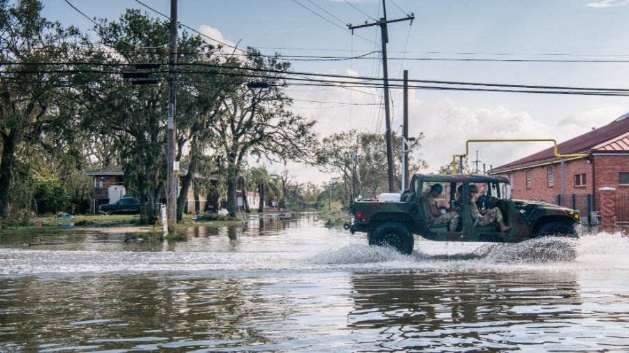 National Guard members ride through the flooding left by Hurricane Ida