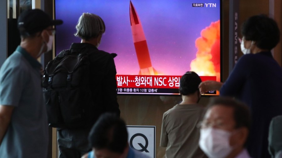 People watch a TV at the Seoul Railway Station showing a file image of a North Korean missile launch