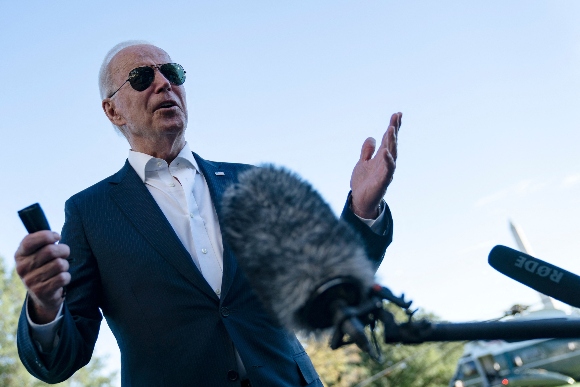 President Joe Biden speaks with reporters on the South Lawn of the White House