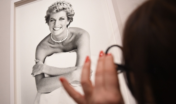 An image of Princess Diana is inspected at the press preview for 'Vogue 100: A Century of Style'