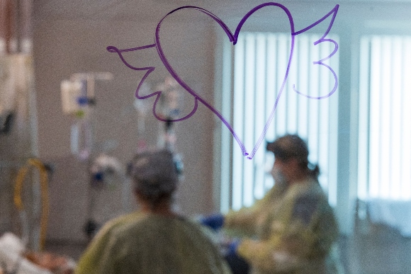 A heart with wings is drawn on the window as nurses care for a Covid-19 patient inside the ICU (intensive care unit) at Adventist Health in Sonora, California