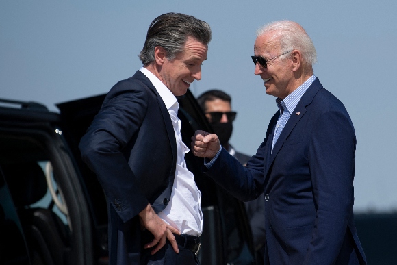 California Governor Gavin Newsom greets US President Joe Biden (R) at Sacramento Mather Airport