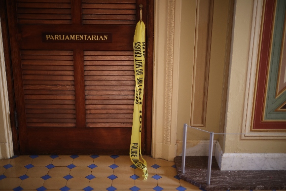 Police tape still hangs from the handle of the door to the Senate Parliamentarian's office