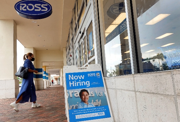 A Now Hiring near the entrance to a Ross department store