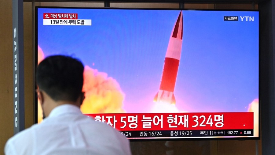 People in South Korea watch a television news broadcast showing file footage of a North Korean missile test