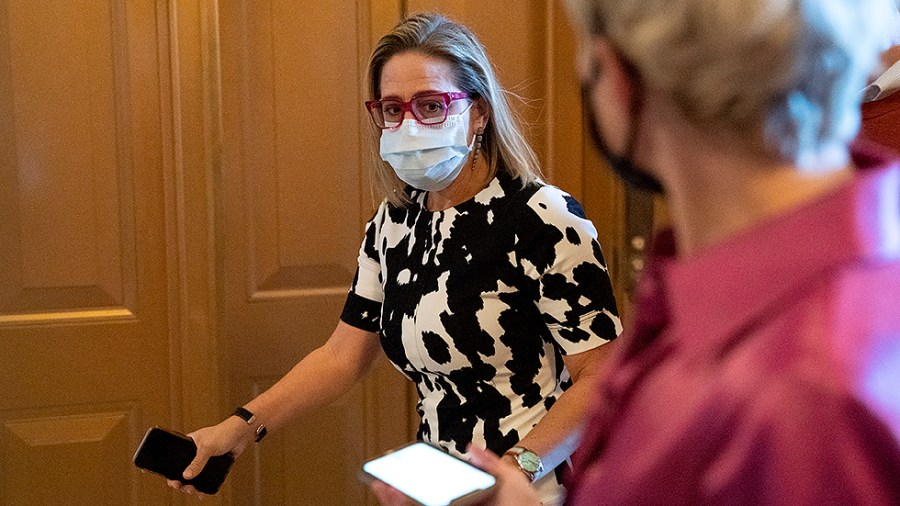 Sen. Kirsten Sinema (D-Ariz.) arrives to the Senate Chamber for a vote regarding a nomination on Wednesday, September 29, 2021.