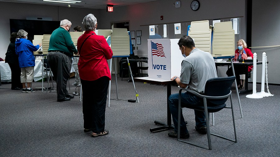 A voter fills out their ballot at a early voting polling site at the Fairfax County Government Center in Fairfax, Va., on Thursday, September 23, 2021.