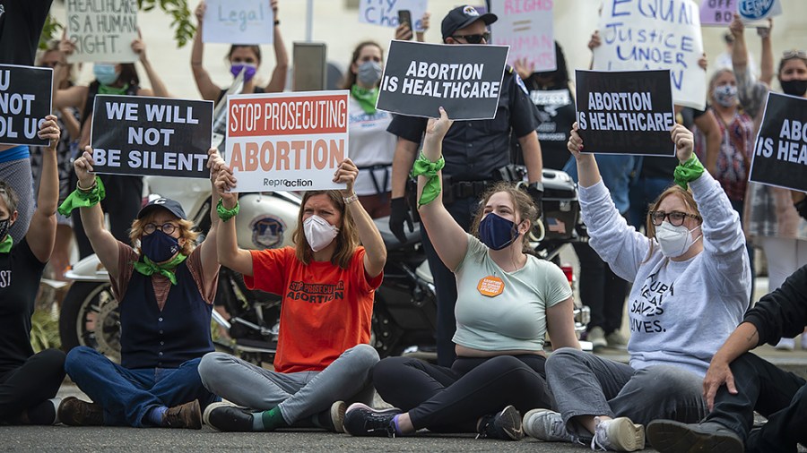 Supporters of legal abortion gather outside the US Supreme Court on the first day of their new term on Monday, October 4, 2021