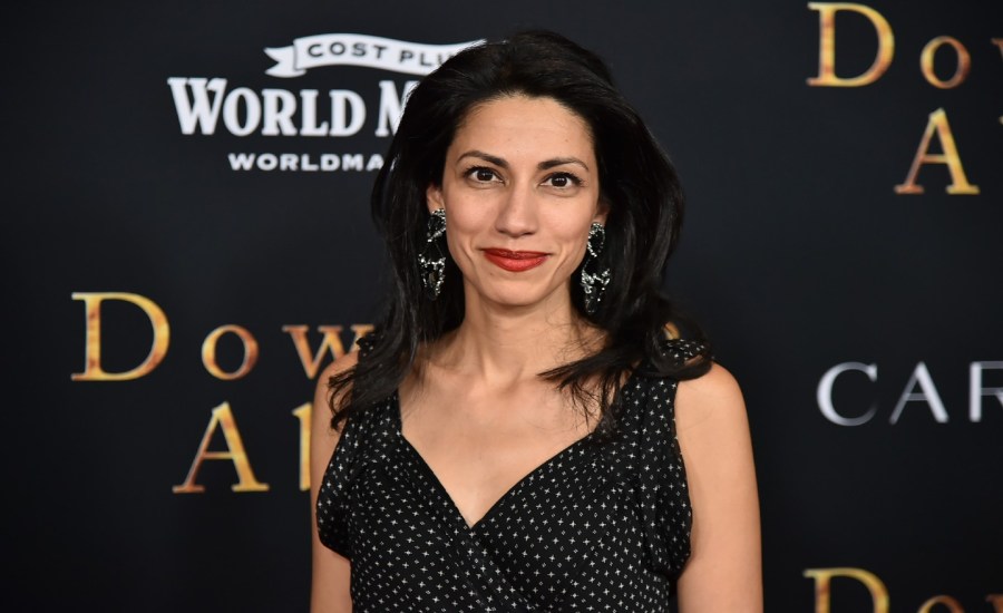 Huma Abedin smiles while posing for a photo.