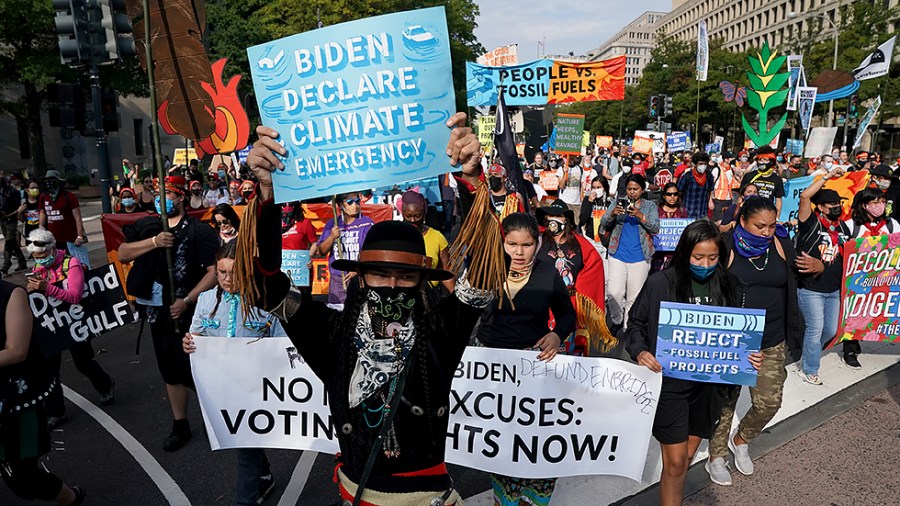 Climate protesters march down Pennsylvania Ave. on their way to the Capitol on Friday, October 15, 2021. The group ‘People vs Fossil Fuels’ want President Biden to end fossil fuel projects and to declare climate change a national emergency.