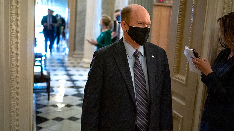 Sen. Chris Coons (D-Del.) leaves the Senate Chamber after nomination votes on Thursday, October 28, 2021.