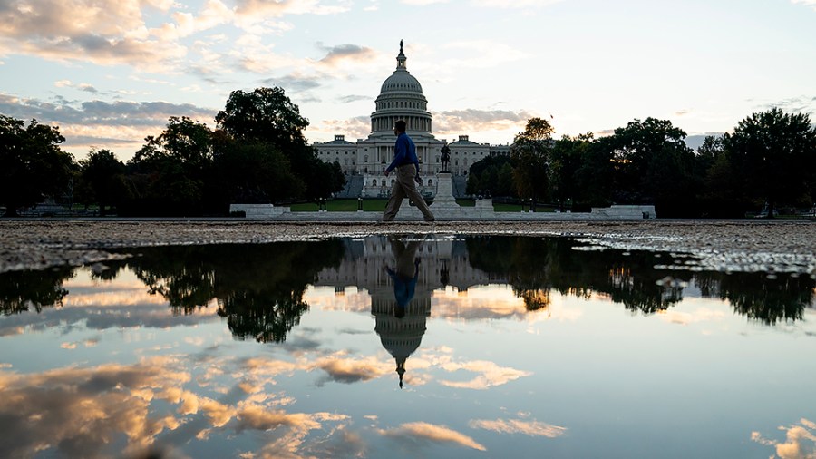 The Capitol is seen from the Capitol Reflecting Pool at sunrise on Tuesday, October 26, 2021.