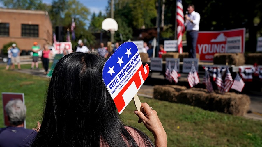 A supporter of Virginia Republican gubernatorial candidate Glenn Youngkin listens to remarks about his education agenda during an event at Eva Walker Park in Warrenton, Va., on Thursday, October 14, 2021.