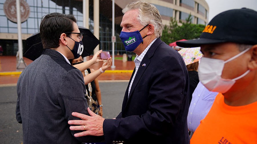 Virginia Democratic gubernatorial candidate Terry McAuliffe greets supporters at a campaign stop outside the Fairfax County Government Center in Fairfax, Va., as the state opens the polls for the first day of early voting on Friday, September 17, 2021.