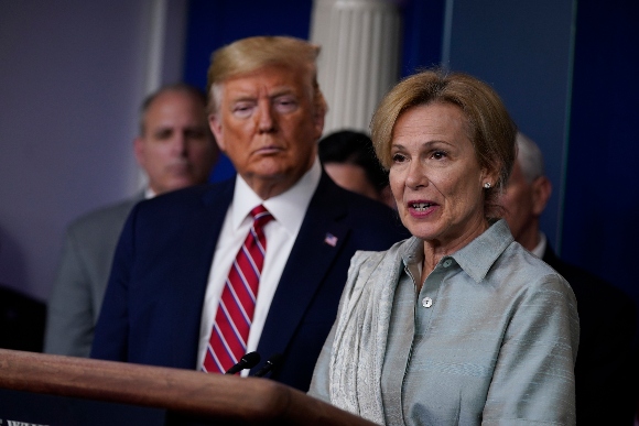 In this March 20, 2020, file photo President Donald Trump listens as White House coronavirus response coordinator Dr. Deborah Birx speaks