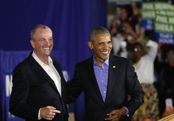 Former U.S. President Barack Obama walks on stage in support of Phil Murphy