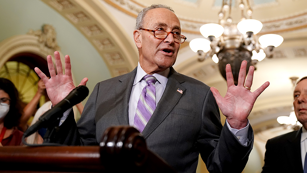 Majority Leader Charles Schumer (D-N.Y.) holds up ten fingers in relation to Senate Republicans as he addresses reporters after the weekly policy luncheon on Tuesday, October 5, 2021.