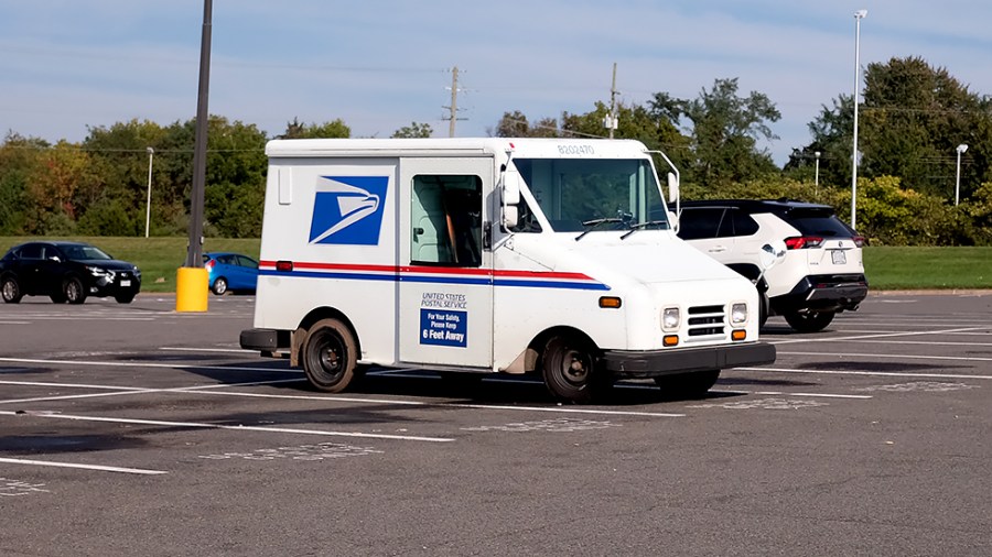 A U.S. Postal Service truck is seen in a parking lot at the Newgate Shopping Center in Centerville, Va., on Thursday, October 14, 2021.