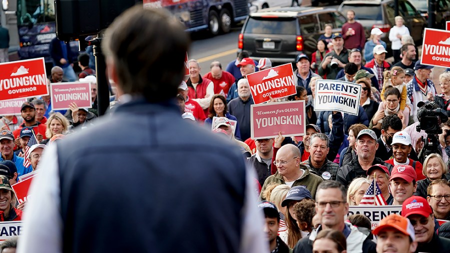 Supporters and potential votes listen to Virginia Republican gubernatorial candidate Glenn Youngkin at the Alexandria Farmers Market in Alexandria, Va., on Saturday, October 30, 2021.