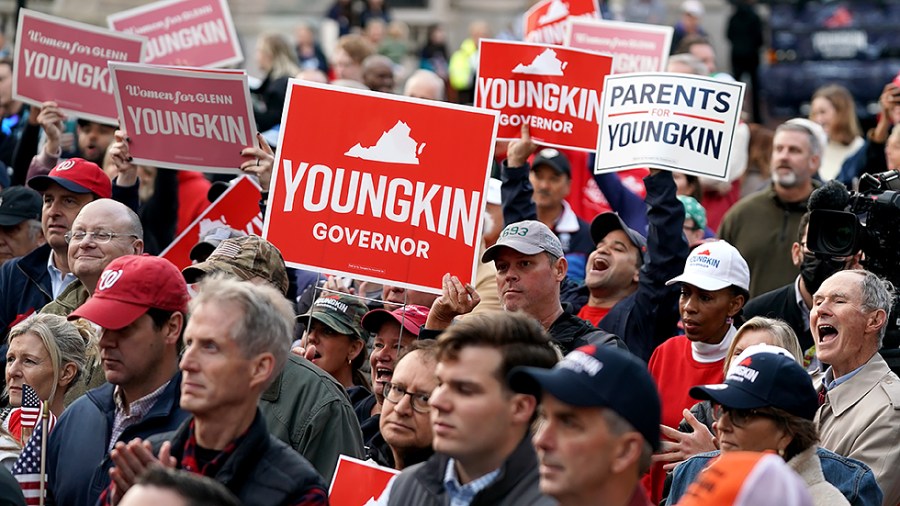 Supporters and potential votes listen to Virginia Republican gubernatorial candidate Glenn Youngkin at the Alexandria Farmers Market in Alexandria, Va., on Saturday, October 30, 2021.