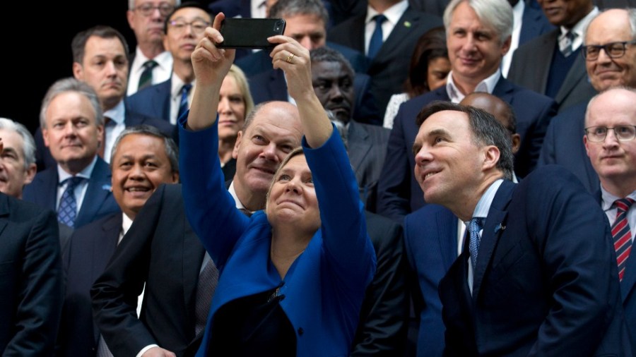 Then-Swedish Finance Minister Magdalena Andersson take a selfie during a International Monetary Fund Governors group photo in 2019