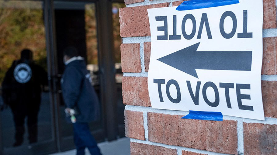 A voter walks in to a building