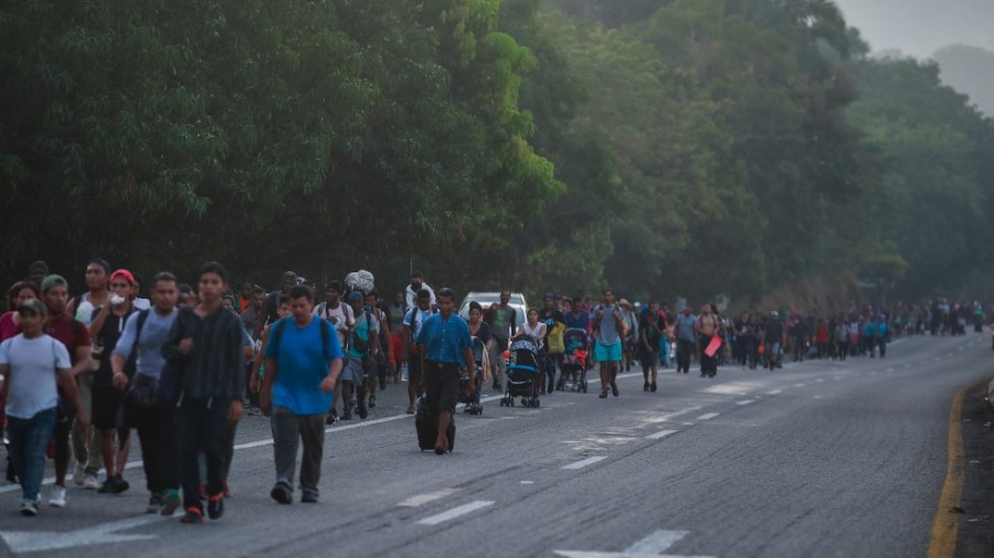 Migrants walk along the highway from Huehuetan to Huixtla in Chiapas state, Mexico