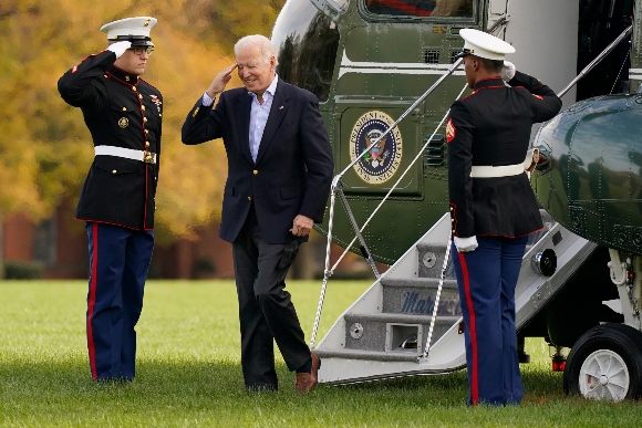 President Joe Biden salutes as he arrives on Marine One at Fort Lesley J. McNair in Washington