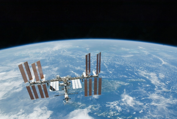 This photo provided by NASA shows the International Space Station with Earth's horizon as a backdrop