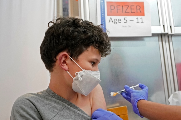 Leo Hahn, 11, gets the first shot of the Pfizer COVID-19 vaccine