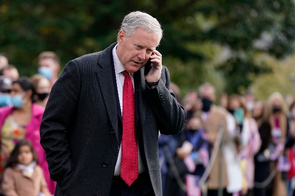 White House chief of staff Mark Meadows speaks on a phone on the South Lawn of the White House