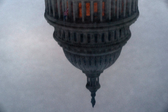 The dome of the U.S. Capitol is reflected on Saturday, Jan. 16, 2021, in Washington