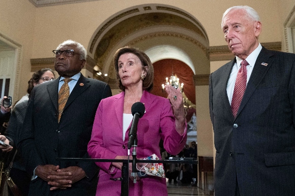 Speaker of the House Nancy Pelosi, D-Calif., accompanied by House Majority Whip James Clyburn, D-S.C., left and House Majority Leader Steny Hoyer D-MD, speaks to reporters